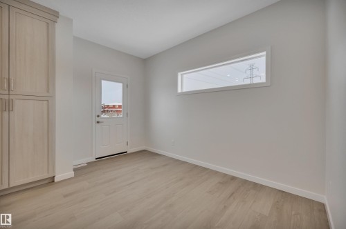 Empty room with light wood-style floors and baseboards - 5742 Hawthorn Common, Edmonton, AB - Indoor Photo Showing Other Room