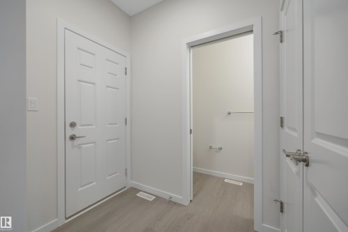 Doorway to outside featuring wood finished floors and baseboards - 5742 Hawthorn Common, Edmonton, AB - Indoor Photo Showing Other Room
