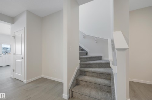 Stairs with wood finished floors and baseboards - 5742 Hawthorn Common, Edmonton, AB - Indoor Photo Showing Other Room