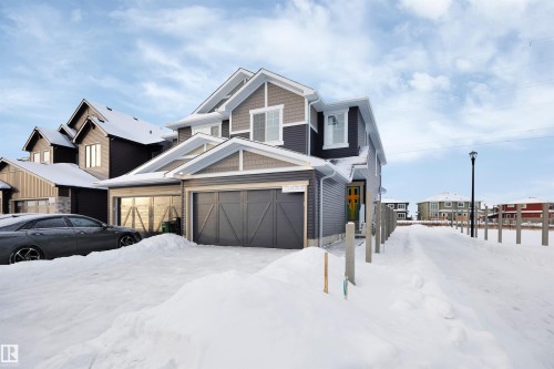 View of front facade with a garage - 5742 Hawthorn Common, Edmonton, AB - Outdoor With Facade