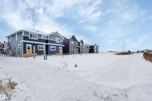 Snow covered back of property with a residential view - 5742 Hawthorn Common, Edmonton, AB - Outdoor With Facade