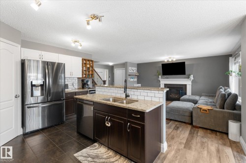 5 South Creek Point(E), Stony Plain, AB - Indoor Photo Showing Kitchen With Fireplace With Double Sink