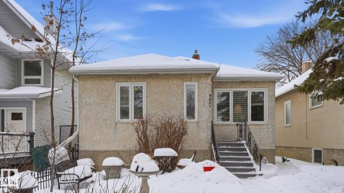 Snow covered rear of property with a chimney - 9831 83 Avenue, Edmonton, AB - Outdoor