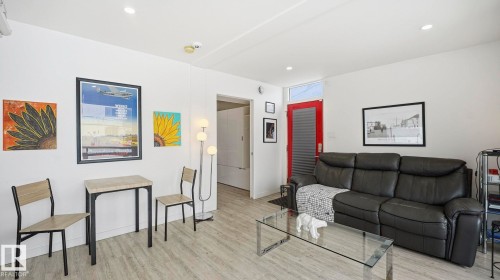 Living area with wood finished floors and recessed lighting - 9831 83 Avenue, Edmonton, AB - Indoor Photo Showing Living Room
