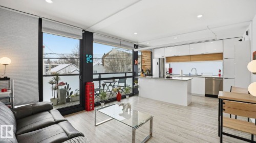 Living room with floor to ceiling windows, light wood-style flooring, and recessed lighting - 9831 83 Avenue, Edmonton, AB - Indoor Photo Showing Living Room