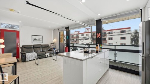 Kitchen featuring modern cabinets, freestanding refrigerator, white cabinets, light countertops, and light wood-style floors - 9831 83 Avenue, Edmonton, AB - Indoor