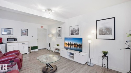 Living room with light wood-type flooring - 9831 83 Avenue, Edmonton, AB - Indoor