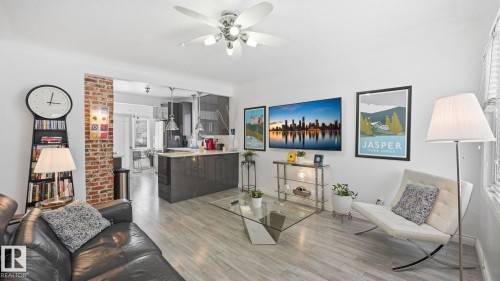 Living room with light wood-style floors and a ceiling fan - 9831 83 Avenue, Edmonton, AB - Indoor Photo Showing Other Room