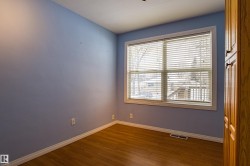 Empty room featuring baseboards and dark wood-style flooring - 