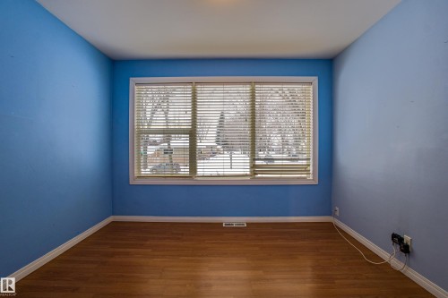 Spare room with dark wood-style flooring and baseboards - 9228 124A Avenue, Edmonton, AB - Indoor Photo Showing Other Room