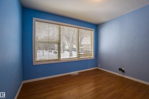 Empty room with baseboards and dark wood-style flooring - 9228 124A Avenue, Edmonton, AB - Indoor Photo Showing Other Room