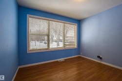 Empty room with baseboards and dark wood-style flooring - 