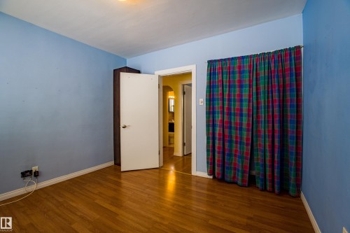 Unfurnished room featuring wood finished floors and arched walkways - 9228 124A Avenue, Edmonton, AB - Indoor Photo Showing Other Room