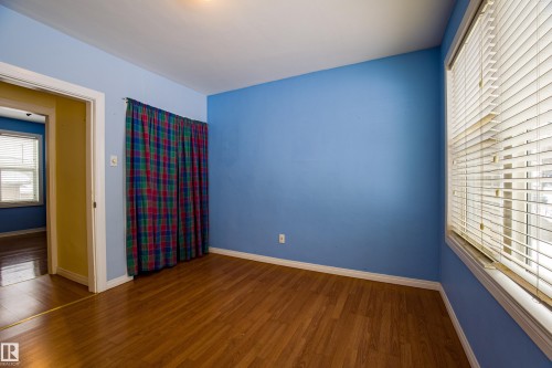 Empty room featuring wood finished floors and baseboards - 9228 124A Avenue, Edmonton, AB - Indoor Photo Showing Other Room