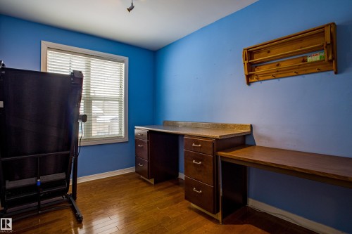 Unfurnished office with dark wood-style floors and baseboards - 9228 124A Avenue, Edmonton, AB - Indoor
