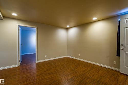 Unfurnished room with dark wood-type flooring and recessed lighting - 9228 124A Avenue, Edmonton, AB - Indoor Photo Showing Other Room