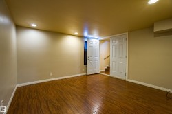 Finished below grade area featuring dark wood-style floors, recessed lighting, and stairs - 