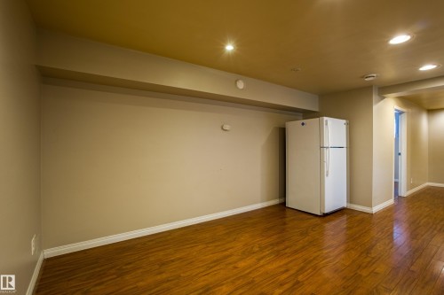 Empty room featuring dark wood-style floors and recessed lighting - 9228 124A Avenue, Edmonton, AB - Indoor Photo Showing Other Room