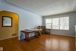 Home office with wood finished floors, arched walkways, and a textured ceiling - 