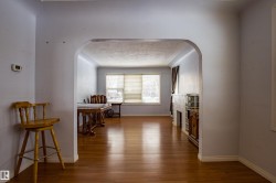 Corridor with arched walkways and dark wood-style floors - 