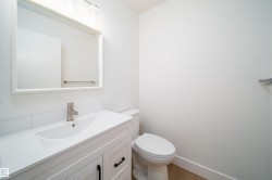 Bathroom with vanity and wood finished floors - 