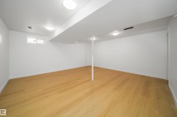 Below grade area with light wood finished floors and baseboards - 