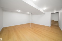 Finished basement featuring light wood-style floors and stairs - 