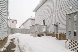 Yard layered in snow with a wooden deck - 