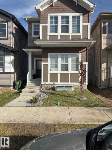 View of front facade featuring covered porch and a front lawn - 343 Edgemont Drive, Edmonton, AB - Outdoor With Facade