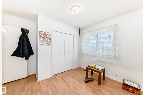 Unfurnished bedroom with a closet, a textured ceiling, and light wood-style flooring - 15515 92A Avenue, Edmonton, AB - Indoor Photo Showing Other Room