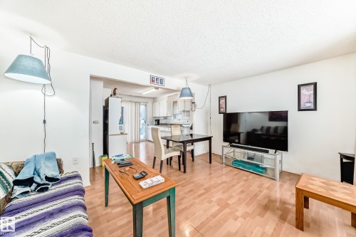 Living area featuring a textured ceiling and light wood-style floors - 15515 92A Avenue, Edmonton, AB - Indoor Photo Showing Living Room