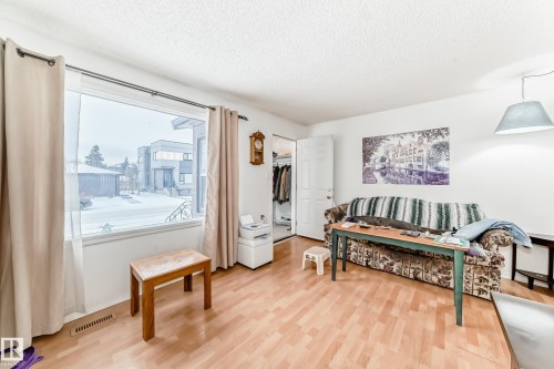Sitting room featuring a textured ceiling and light wood-type flooring - 15515 92A Avenue, Edmonton, AB - Indoor