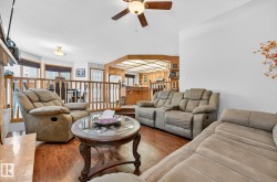 Living room with hardwood / wood-style floors and a ceiling fan - 