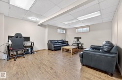 Home office with wood finished floors and a drop ceiling - 