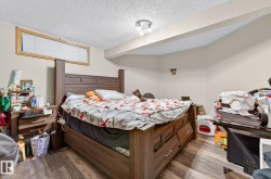 Bedroom featuring a textured ceiling and wood finished floors - 