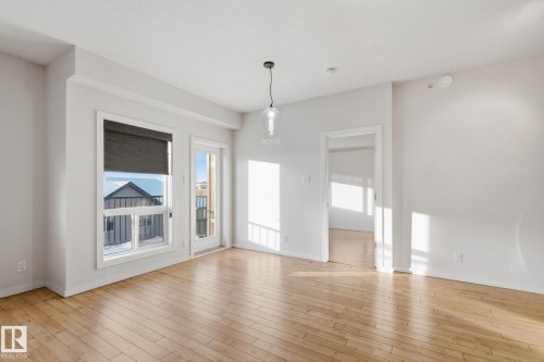 Empty room featuring light wood-style floors - 405 9517 160 Avenue, Edmonton, AB - Indoor