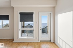 Doorway featuring hardwood / wood-style floors and baseboards - 