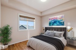 Bedroom with hardwood / wood-style flooring and baseboards - 