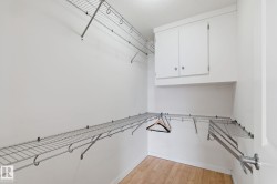 Walk in closet featuring light wood finished floors - 