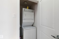 Laundry room with stacked washer and clothes dryer - 