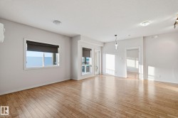 Unfurnished living room with light wood-style floors, healthy amount of natural light, and a textured ceiling - 