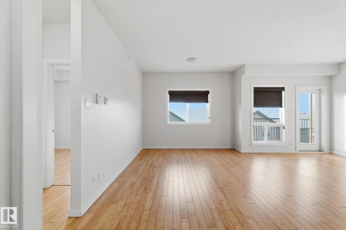 Spare room with light wood-style flooring and baseboards - 405 9517 160 Avenue, Edmonton, AB - Indoor