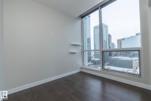 Unfurnished room with a view of city and dark wood-style floors - 1201 10238 103 Street, Edmonton, AB - Indoor Photo Showing Other Room