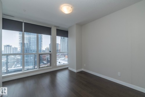 Unfurnished room featuring a view of city and dark wood finished floors - 1201 10238 103 Street, Edmonton, AB - Indoor Photo Showing Other Room