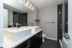 Bathroom with a shower stall, double vanity, and a tub to relax in - 