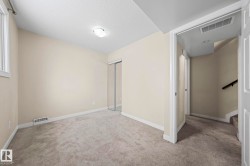 Unfurnished bedroom featuring a textured ceiling, carpet, and a closet - 