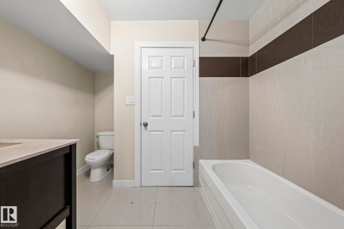 Full bathroom featuring vanity, light tile patterned flooring, and shower / tub combination - 15 Northwoods Village, Edmonton, AB - Indoor Photo Showing Bathroom