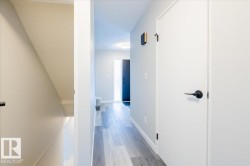 Corridor with baseboards and light wood-style floors - 