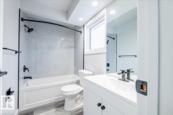 Full bathroom featuring vanity, washtub / shower combination, and light wood-style flooring - 