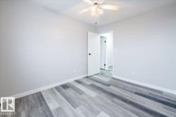 Spare room with wood finished floors and a ceiling fan - 